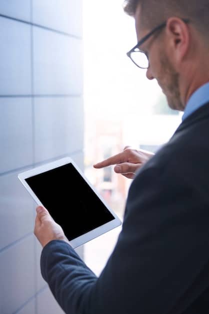 A close-up image of a sales professional reviewing AI-generated insights on a tablet. The tablet screen displays a customer profile with key data points, including their past interactions, pain points, and potential objections. The scene highlights the accessibility and usability of AI-powered sales tools.